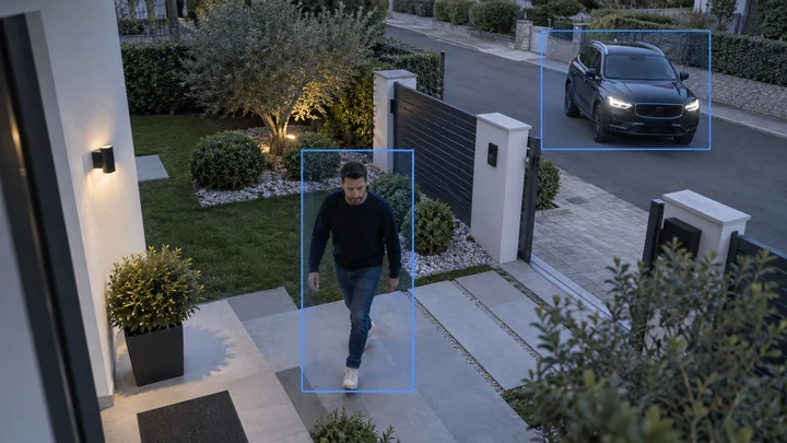 AI camera analytics detecting a person and vehicle at a residential entrance